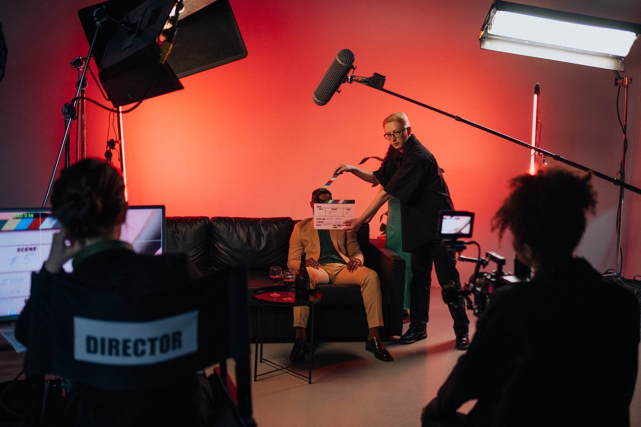 A Person in Black Shirt Holding a Clapperboard during the Filming